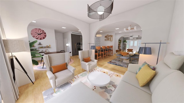 living room featuring an inviting chandelier and light hardwood / wood-style floors