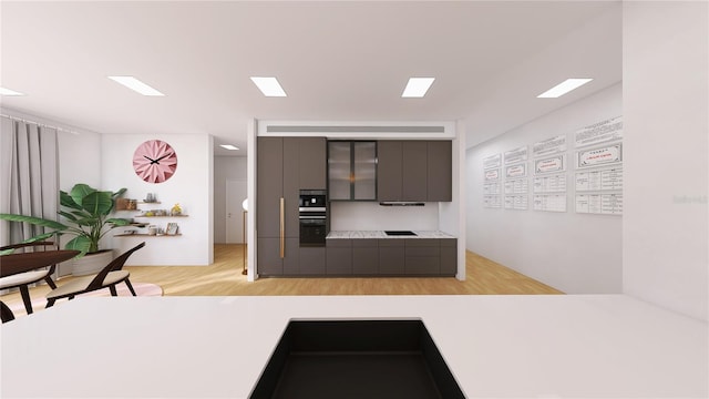 kitchen featuring gray cabinetry and light hardwood / wood-style flooring