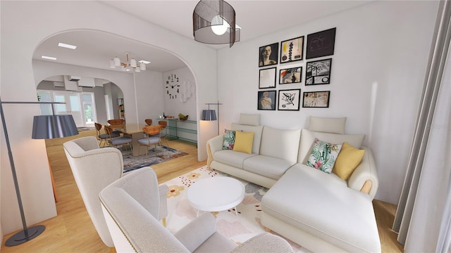 living room with a chandelier and light wood-type flooring