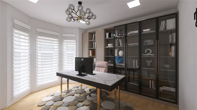 office space with an inviting chandelier and light wood-type flooring