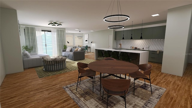 dining space with a chandelier and light wood-type flooring