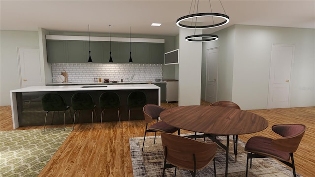 dining area with a chandelier and light hardwood / wood-style floors