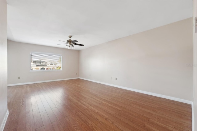 spare room featuring wood-type flooring and ceiling fan