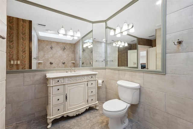 bathroom with tile walls, oversized vanity, toilet, and tile floors