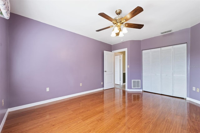 unfurnished bedroom with a closet, ceiling fan, and light wood-type flooring