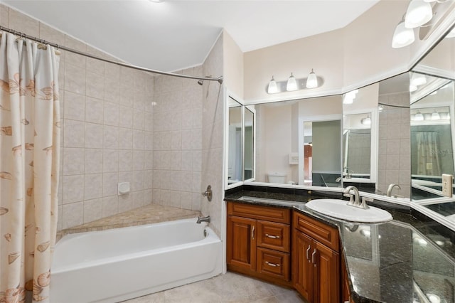 bathroom with vanity, tile flooring, and shower / bath combo with shower curtain