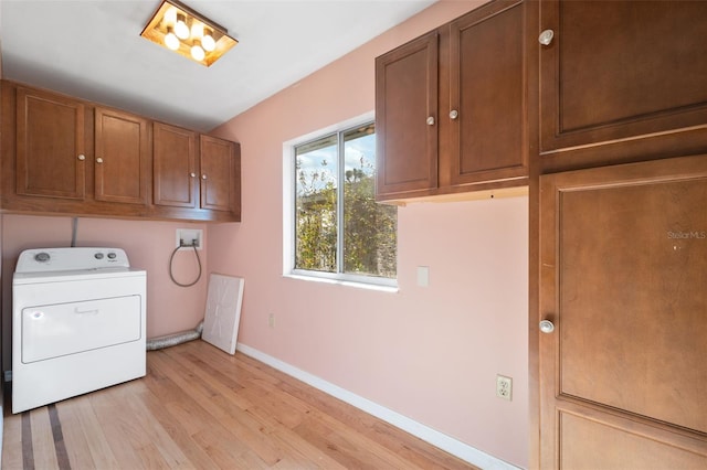 laundry room with cabinets, washer / dryer, and light wood-type flooring