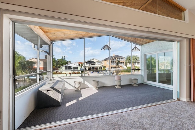 unfurnished sunroom featuring lofted ceiling and wood ceiling