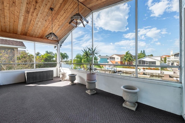 unfurnished sunroom with lofted ceiling and wood ceiling