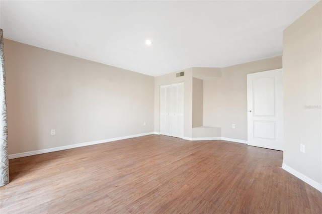 spare room with light hardwood / wood-style floors