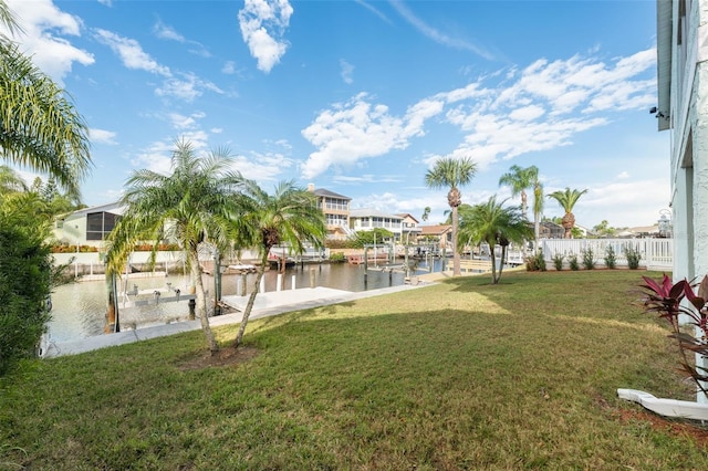 view of yard featuring a water view and a dock