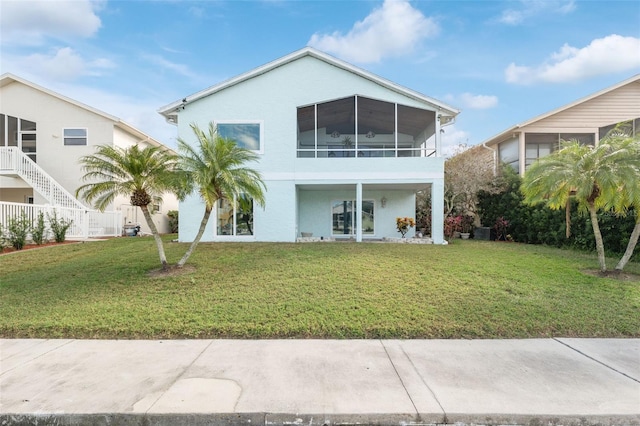 back of property featuring a lawn, central AC unit, and a sunroom