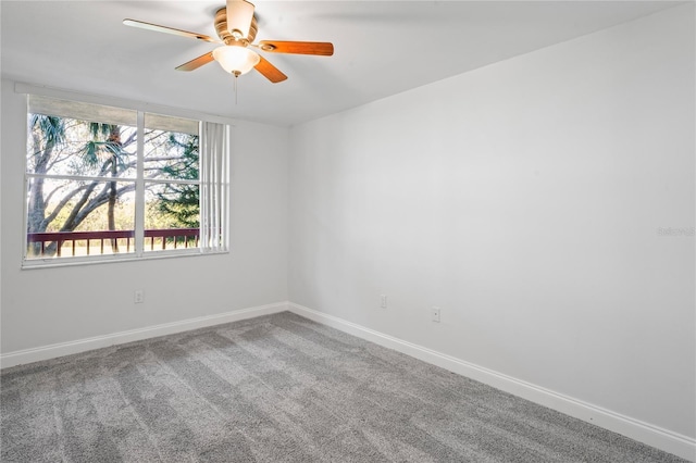 carpeted spare room with ceiling fan