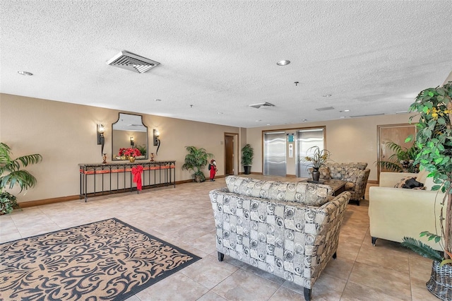 living room featuring light tile patterned flooring and a textured ceiling