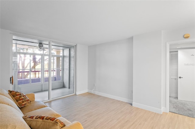 living room with ceiling fan and light hardwood / wood-style floors