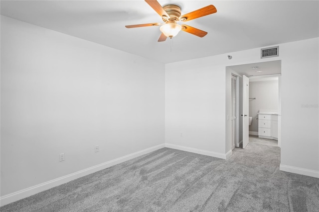 carpeted spare room with ceiling fan