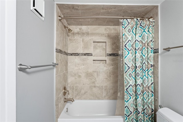 bathroom featuring toilet and shower / bath combo with shower curtain