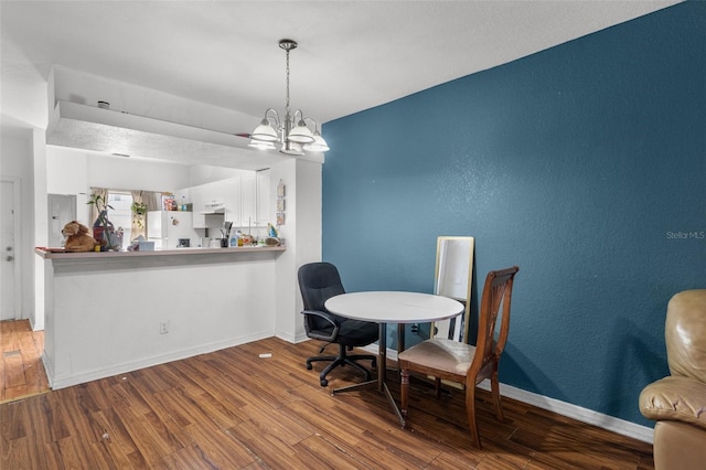 dining room with a chandelier and hardwood / wood-style floors