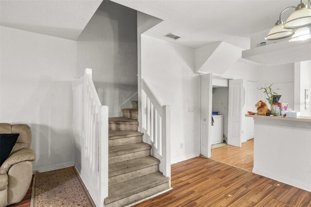 staircase featuring light hardwood / wood-style flooring