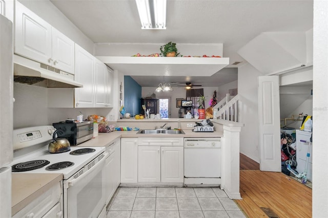 kitchen featuring white appliances, light tile patterned floors, kitchen peninsula, white cabinets, and ceiling fan