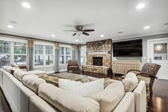 living room featuring a fireplace, hardwood / wood-style flooring, ceiling fan, and ornamental molding