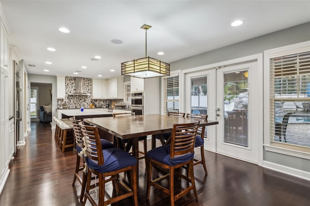 dining room with french doors, dark hardwood / wood-style floors, and a healthy amount of sunlight