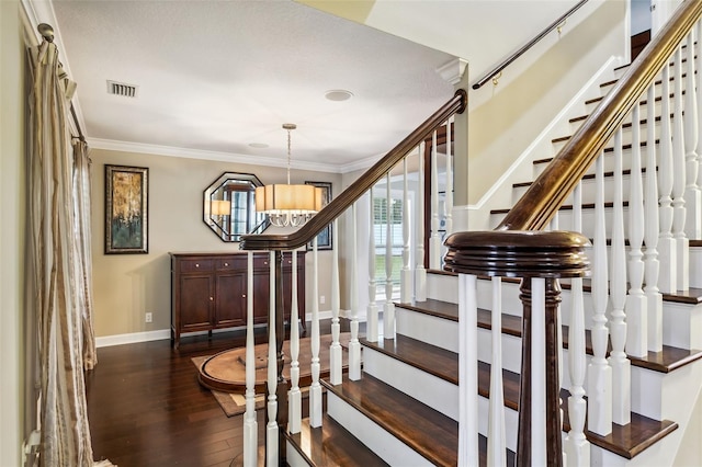 stairs with a chandelier, wood-type flooring, and crown molding