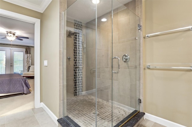 bathroom featuring french doors, crown molding, tile patterned flooring, ceiling fan, and a shower with shower door