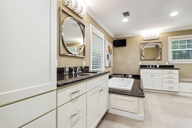 bathroom featuring vanity, a bath, a textured ceiling, and ornamental molding