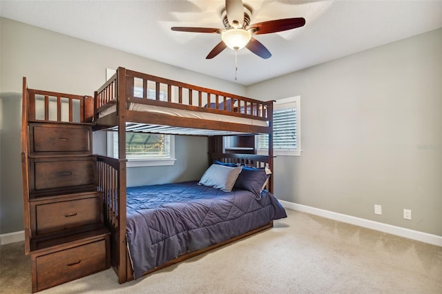 bedroom featuring multiple windows, ceiling fan, and carpet floors