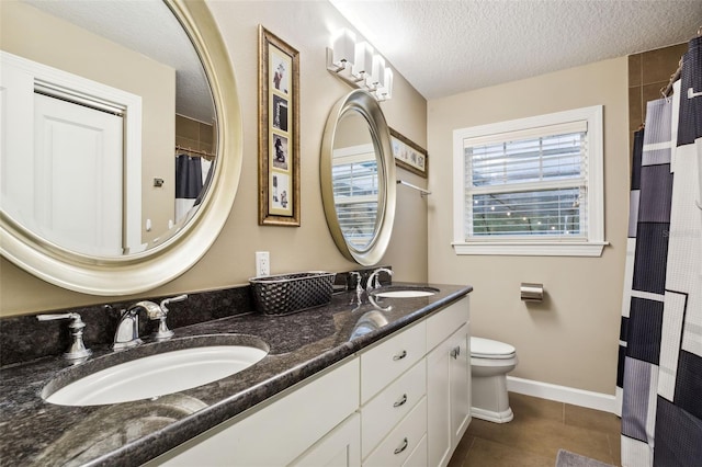 bathroom featuring tile patterned floors, vanity, a textured ceiling, toilet, and curtained shower