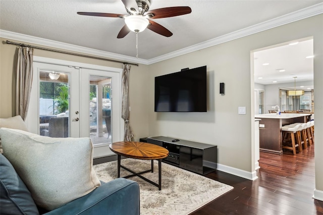 living room featuring french doors, dark hardwood / wood-style flooring, ceiling fan, and crown molding