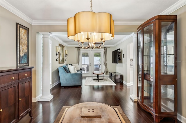 living room with a notable chandelier, dark hardwood / wood-style flooring, crown molding, and french doors