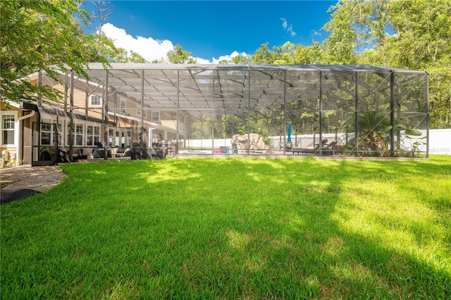 view of yard with a lanai and a swimming pool