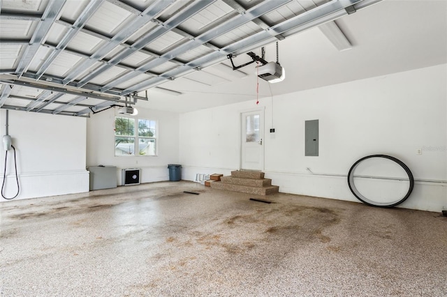 garage with electric panel and a garage door opener