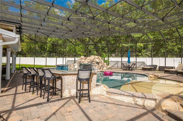 view of patio with a fenced in pool, an outdoor bar, and glass enclosure