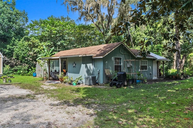 exterior space featuring a lawn and central AC