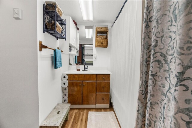 bathroom featuring vanity, hardwood / wood-style flooring, and a shower with curtain