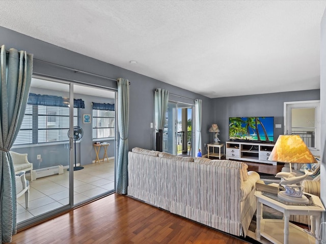 5108 Amulet Dr Unit 206, New Port Richey, FL 34652 - living room featuring wood-type flooring, a textured ceiling, and a baseboard heating unit