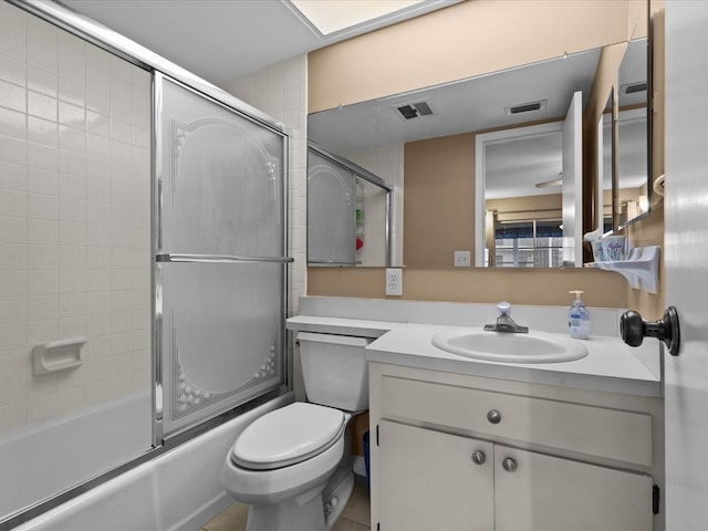 5108 Amulet Dr Unit 206, New Port Richey, FL 34652 - full bathroom featuring combined bath / shower with glass door, vanity, toilet, and tile patterned flooring