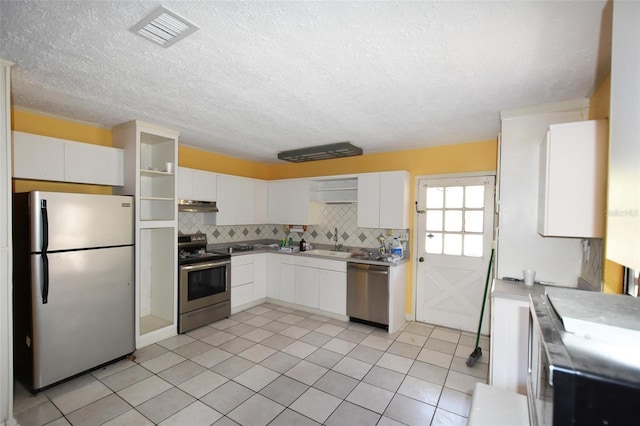 kitchen with decorative backsplash, appliances with stainless steel finishes, sink, and light tile patterned floors