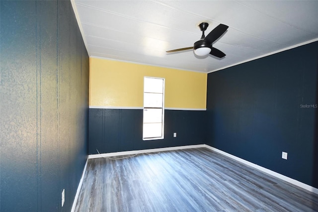 empty room with ceiling fan, ornamental molding, and hardwood / wood-style flooring