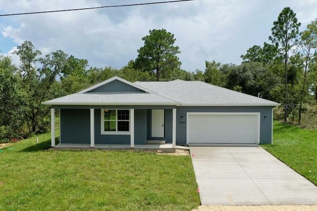 ranch-style home with covered porch, a front yard, and a garage