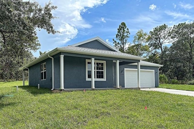 view of front of house featuring a front lawn, covered porch, and a garage