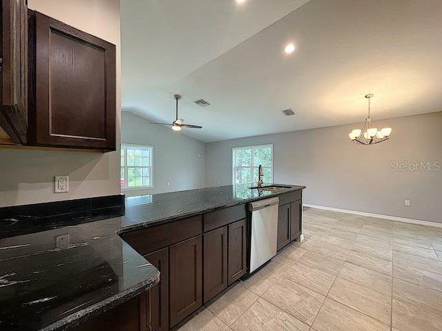 kitchen with sink, stainless steel dishwasher, dark stone counters, and a healthy amount of sunlight