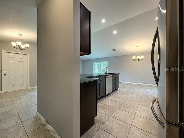 kitchen with stainless steel appliances, sink, an inviting chandelier, and decorative light fixtures