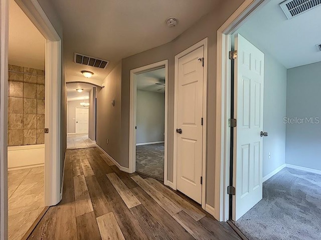 hallway with wood-type flooring