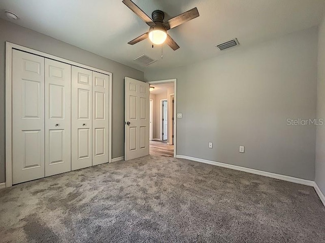 unfurnished bedroom featuring a closet, ceiling fan, and carpet flooring