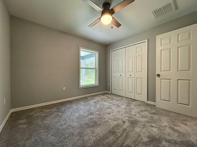 unfurnished bedroom with a closet, ceiling fan, and carpet flooring