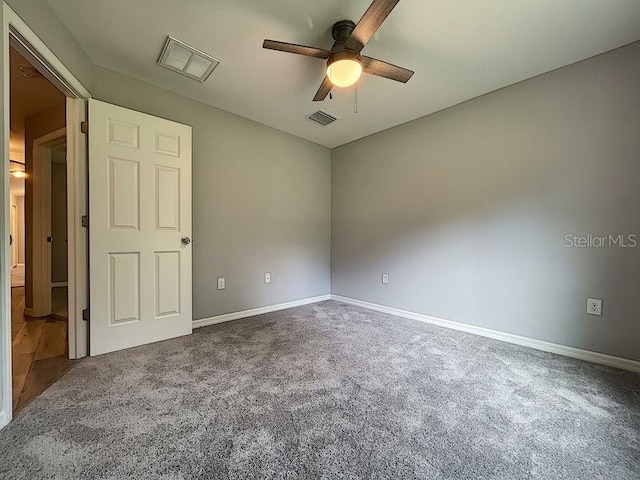 carpeted spare room with ceiling fan